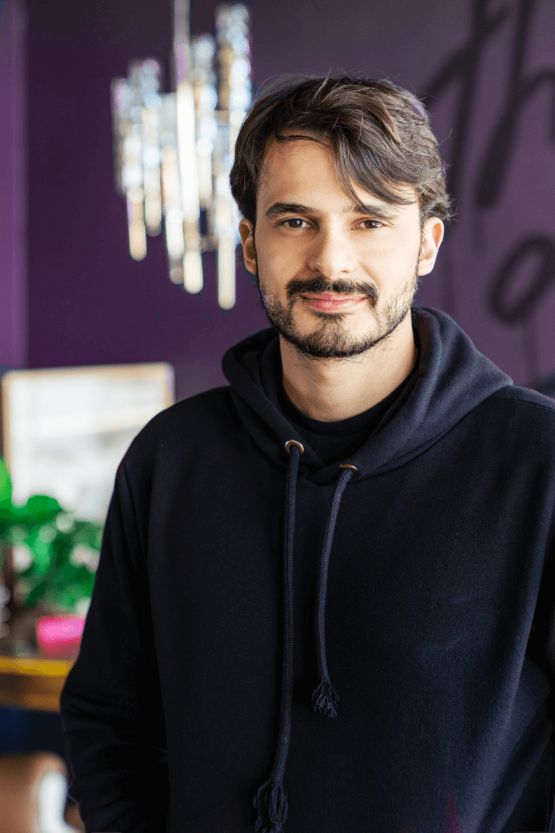 Rapaz feliz em roxo olhando para frente